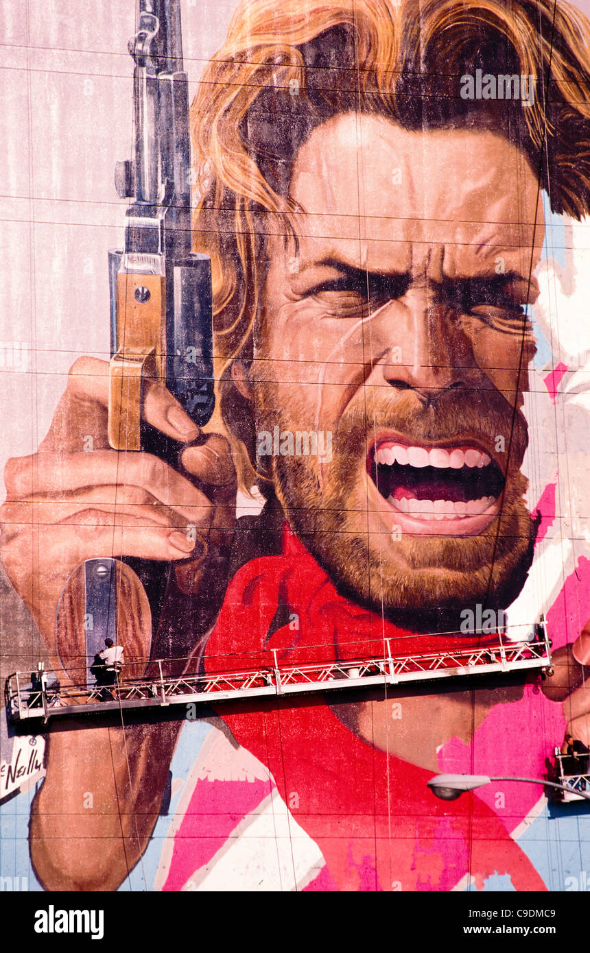 workers post giant billboard of Clint Eastwood on building on Sunset Boulevard Hollywood Los Angeles Southern California Stock Photo