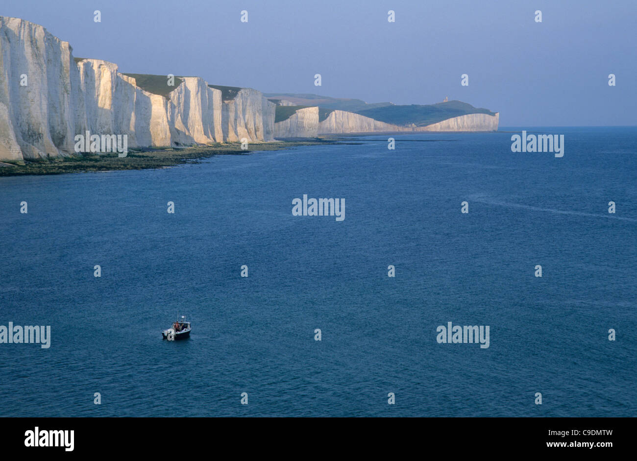 A lone motor boat under the cliffs of the Seven Sisters near Eastbounre, East Sussex, England. Stock Photo