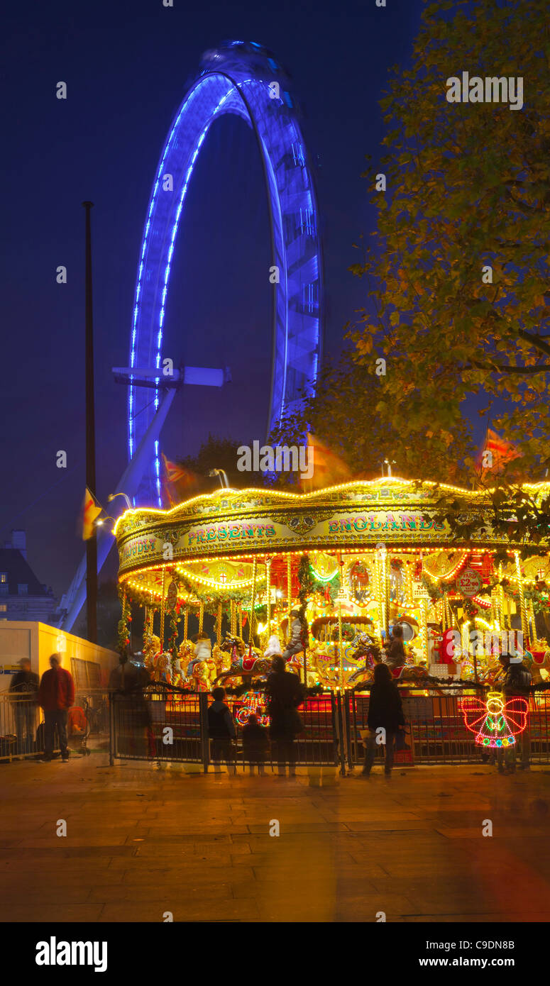 Carousel on the South Bank, at night, illuminated London eye Stock Photo