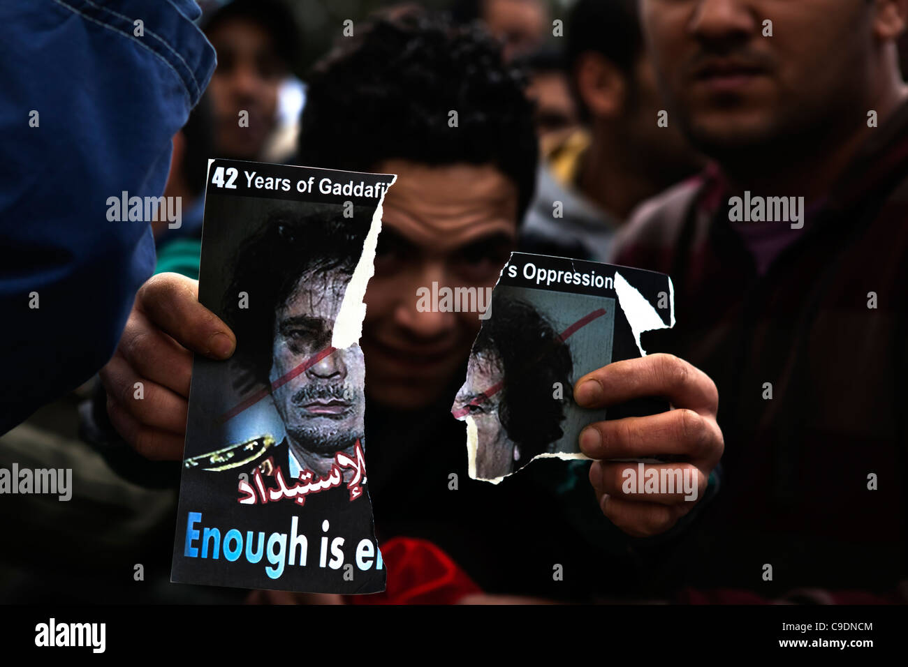 Libyan protester holds up anti-Ghaddafi flyer in front of the camera Stock Photo