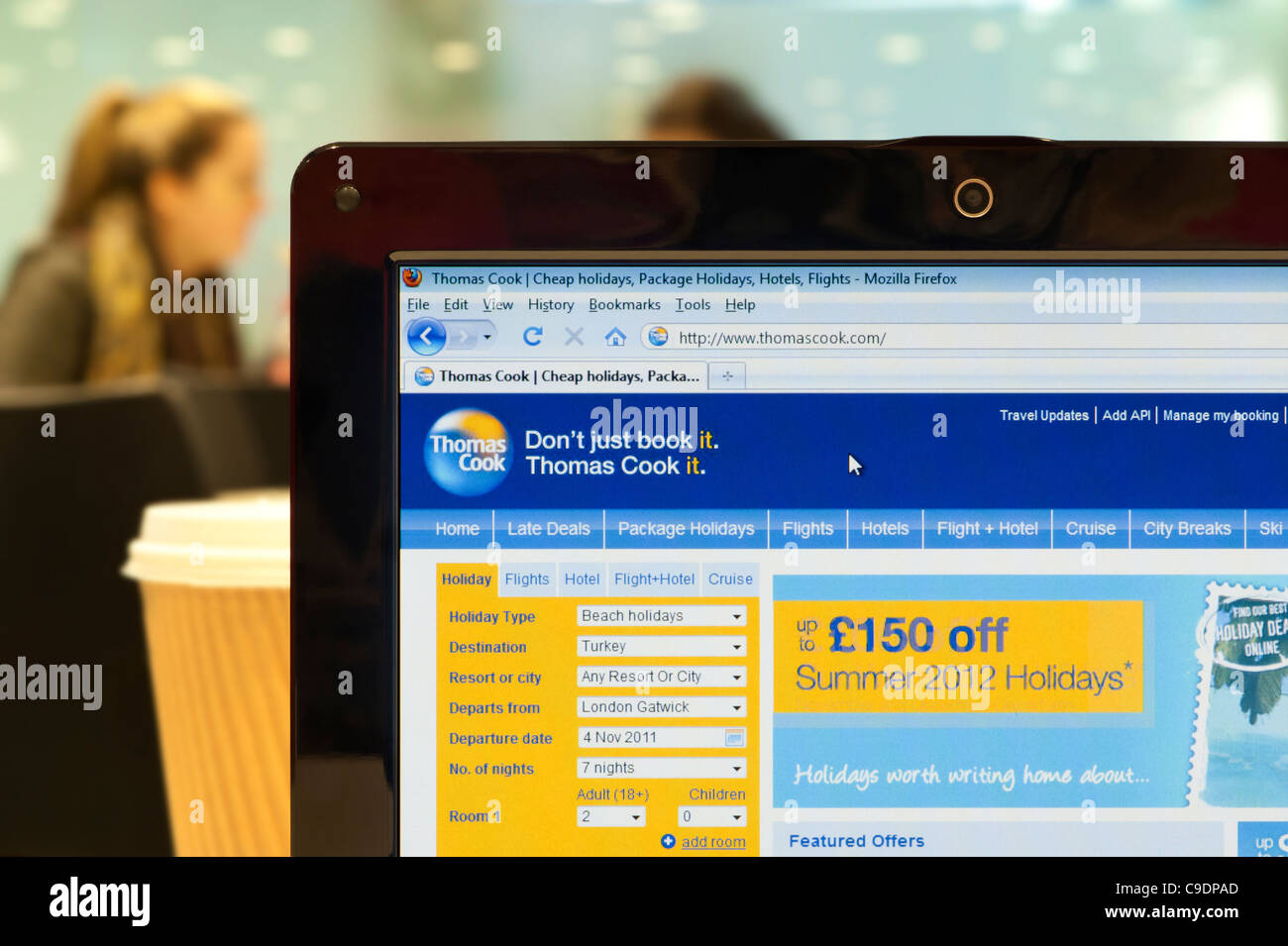 The Thomas Cook website shot in a coffee shop environment (Editorial use only: print, TV, e-book and editorial website). Stock Photo