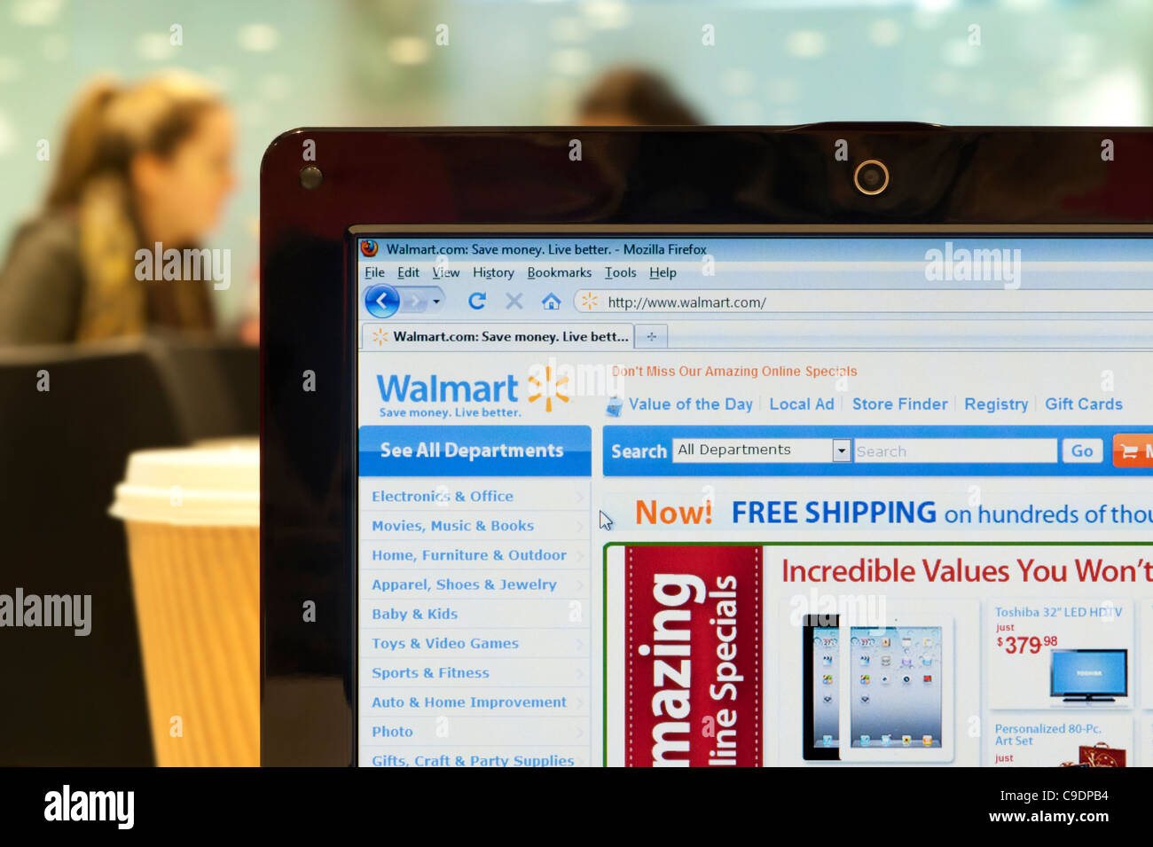 The Walmart website shot in a coffee shop environment (Editorial use only: print, TV, e-book and editorial website). Stock Photo