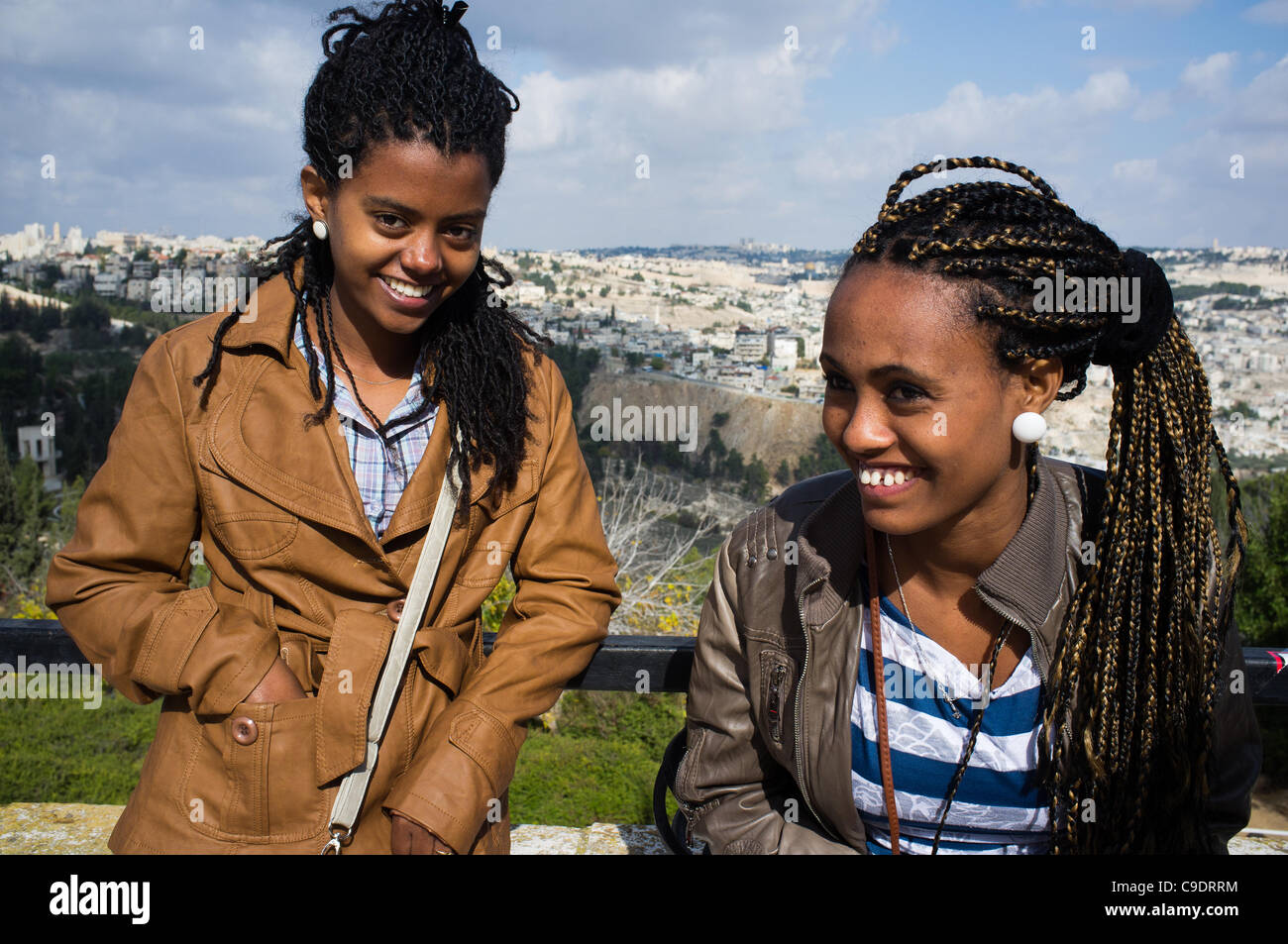 Two young women pose for photo as the Jewish Ethiopian community in Israel celebrates the Sigd Holiday, symbolizing their yearning for Jerusalem, at the Sherover Promenade overlooking the Temple Mount. Jerusalem, Israel. 24th November 2011. Stock Photo