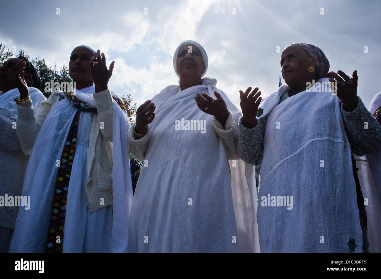 Ethiopian women take part in prayer as the Jewish Ethiopian community in Israel celebrates the Sigd Holiday, symbolizing their yearning for Jerusalem, at the Sherover Promenade overlooking the Temple Mount. Jerusalem, Israel. 24th November 2011. Stock Photo