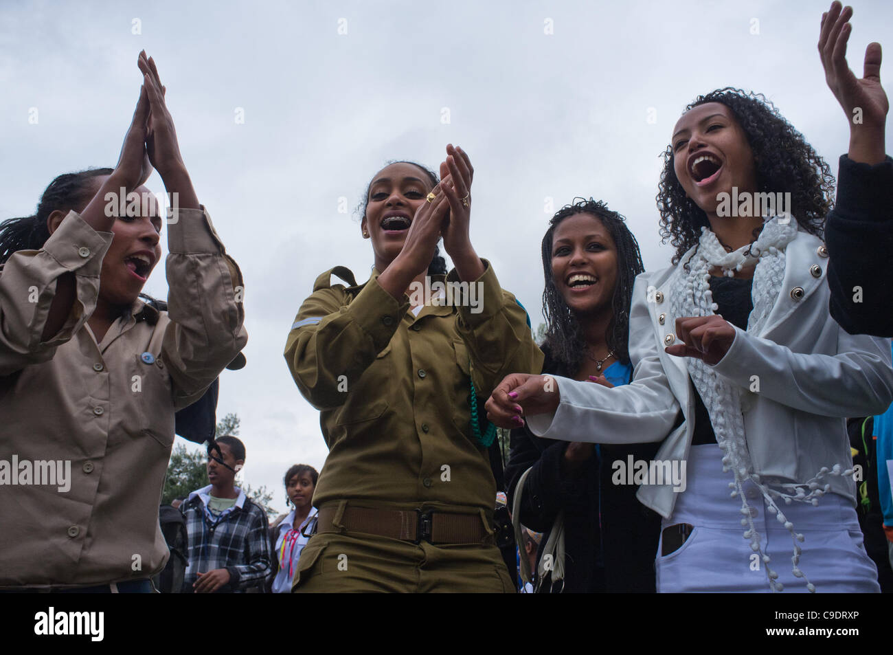 Young women, including Ethiopian IDF soldiers, dance in a women-only dance circle celebrating the Sigd Holiday, symbolizing their yearning for Jerusalem, at the Sherover Promenade overlooking the Temple Mount. Jerusalem, Israel. 24th November 2011. Stock Photo