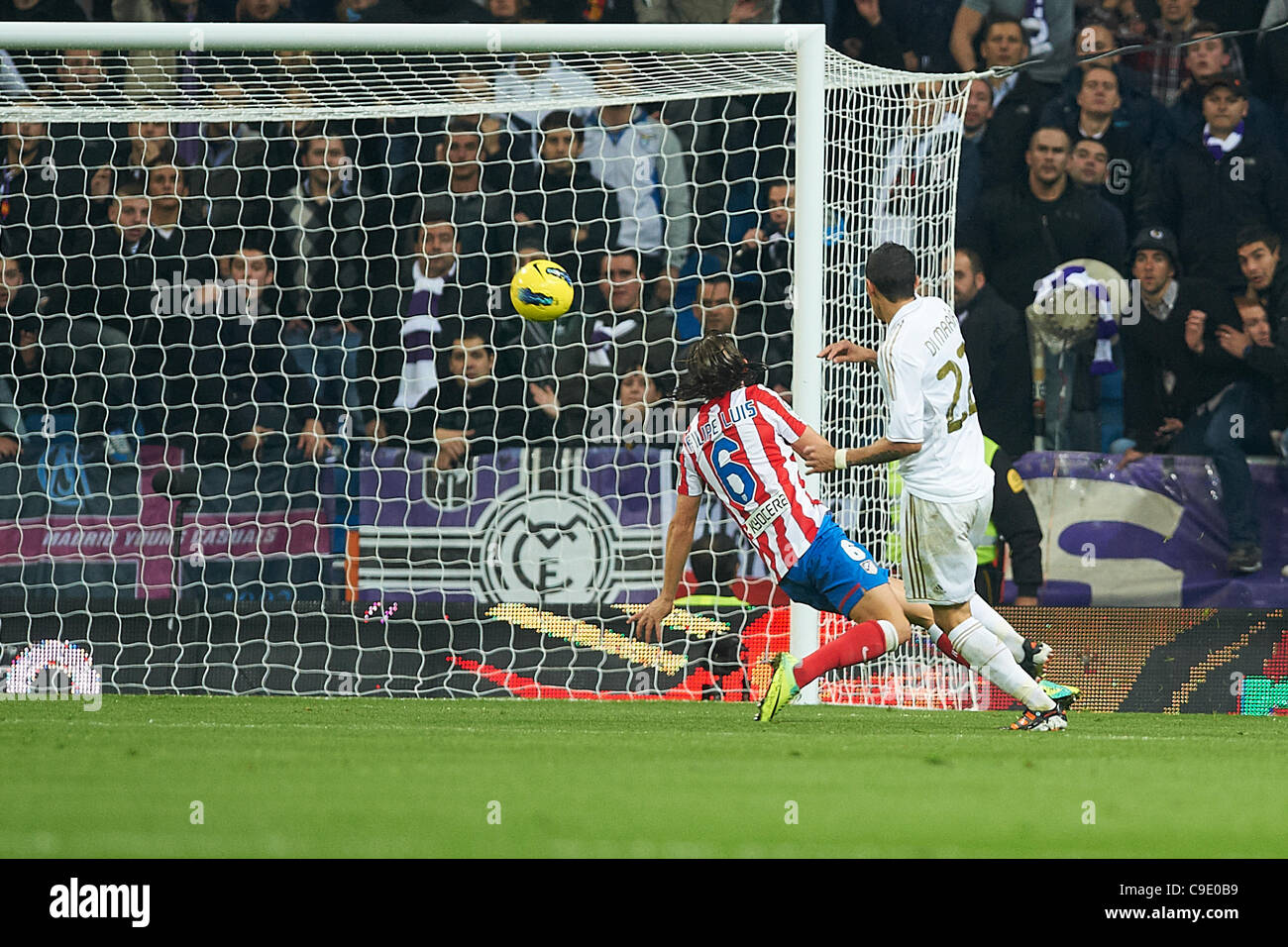 26.11.2011.  MADRID, SPAIN -  Angel Di Maria (r) of Real Madrid scores a goal  with Filipe Luis (l) of Atletico de Madrid in apposition during the La Liga match played between Real Madrid and Atletico de Madrid at Santiago Bernabeu stadium on November 26 in Madrid, Spain. Stock Photo