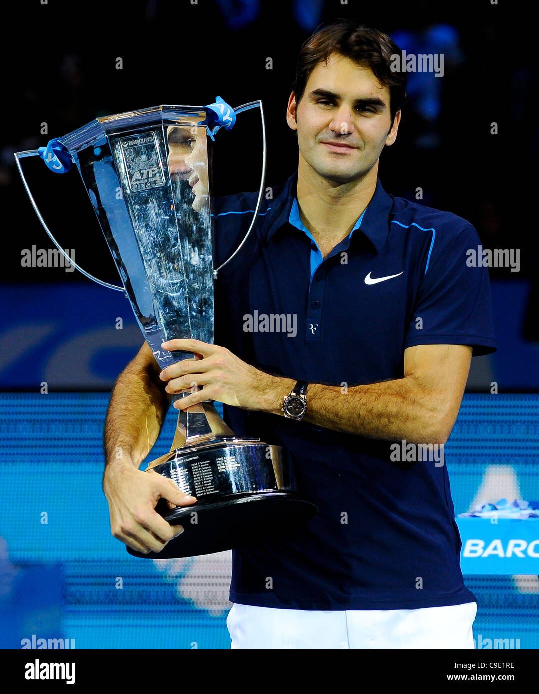 27.11.2011 London, England. [4] Roger Federer (SUI) poses with his Champion  trophy after beating [7] Jo-Wilfried Tsonga (FRA) by two sets to one in the  Final of the Barclays ATP World Tour