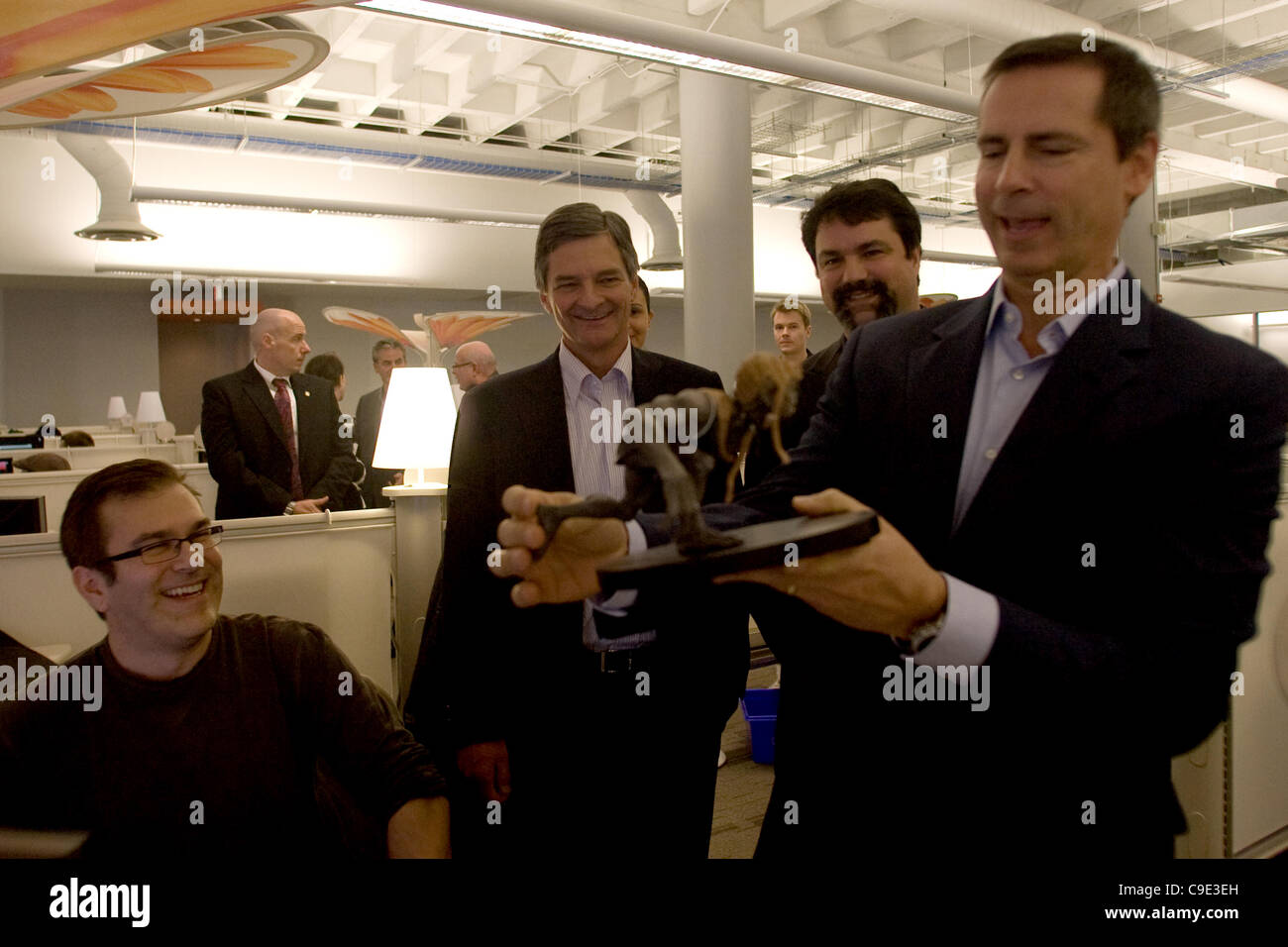 London Ontario, Canada - November 28, 2011. Dalton McGuinty, Premier of Ontario, right looks over a 'Darkling' statue and shares a joke with Jeff Ross, left, Chris Bentley MPP - London West and James Schmalz, president and founder of Digital Extremes. McGuinty was in London to make a funding announc Stock Photo