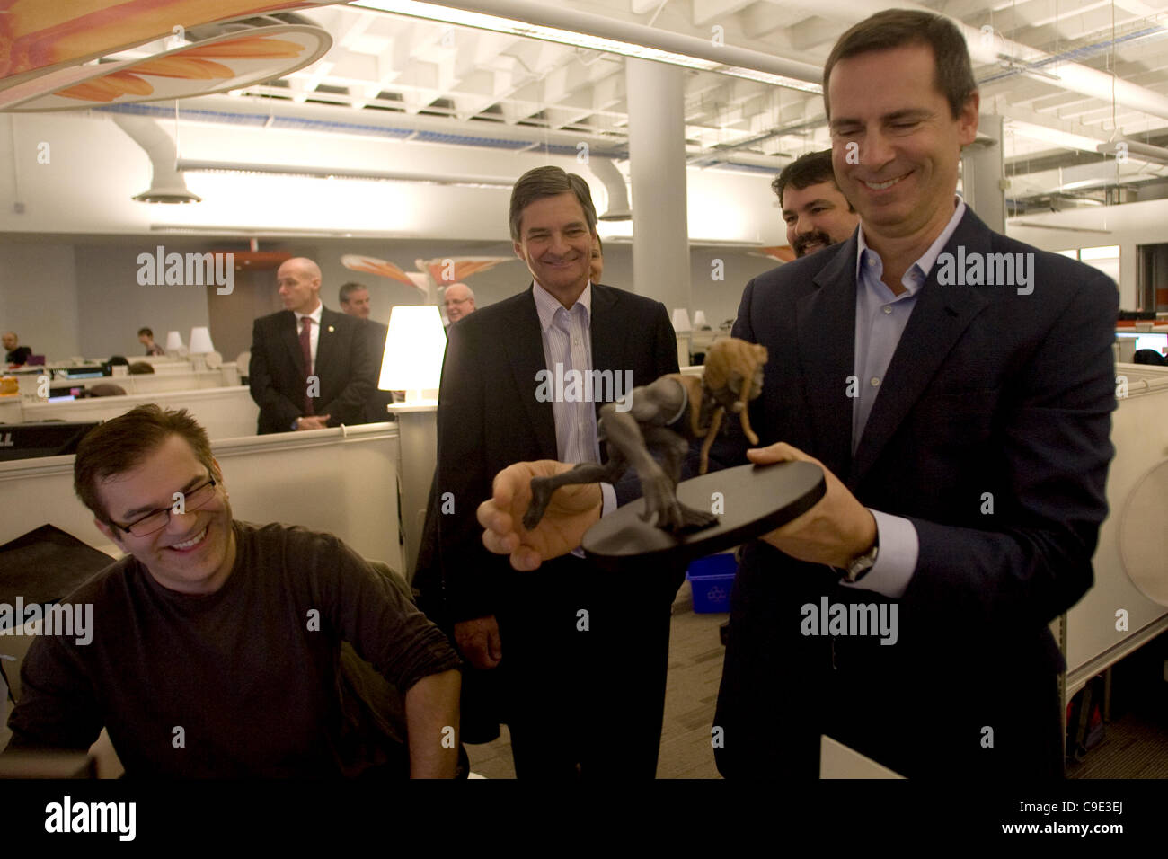 London Ontario, Canada - November 28, 2011. Dalton McGuinty, Premier of Ontario, right looks over a 'Darkling' statue and shares a joke with Jeff Ross, left, Chris Bentley MPP - London West and James Schmalz, president and founder of Digital Extremes. McGuinty was in London to make a funding announc Stock Photo