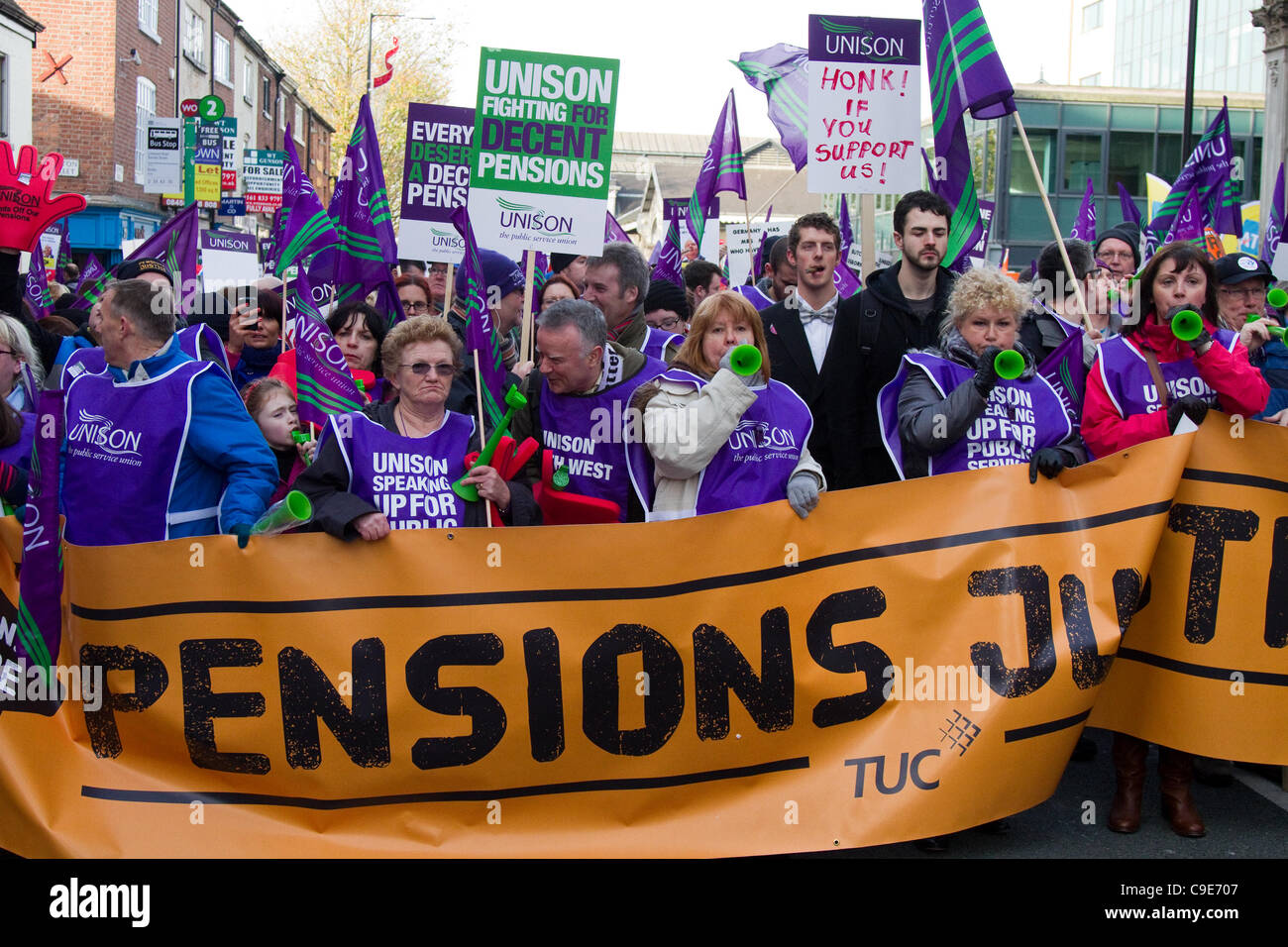 Unison March Manchester, UK. 30th Nov, 2011. Striking public sector workers march in Manchester City Centre in protest over Government pension plans. displaying large 'pensions Justice' banner. Stock Photo