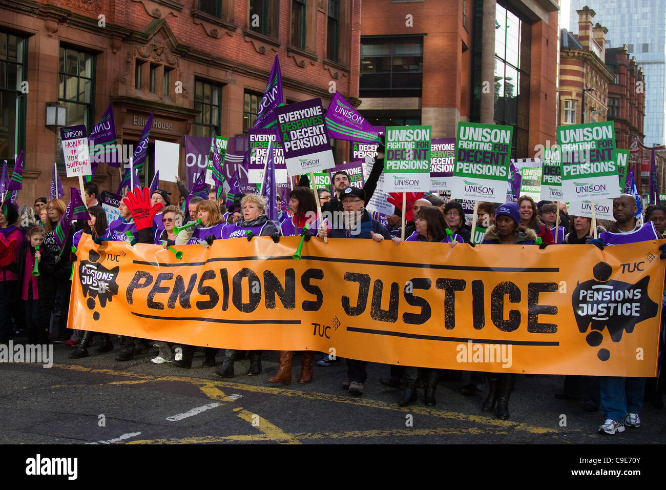 Unison March Manchester, UK. 30th Nov, 2011. Striking UNISON public sector workers march in Manchester City Centre, in protest over Government pension plans, displaying large 'pensions Justice' banner. Stock Photo