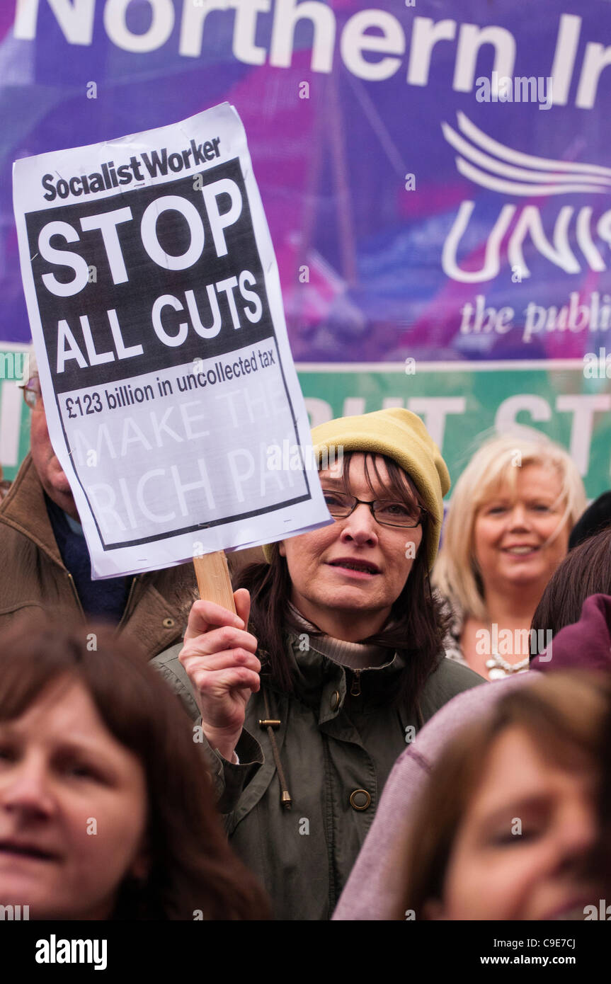 BELFAST 30/11/2011 - Woman holds banner from 'Socialist Worker' calling on a Stop to all cuts Stock Photo