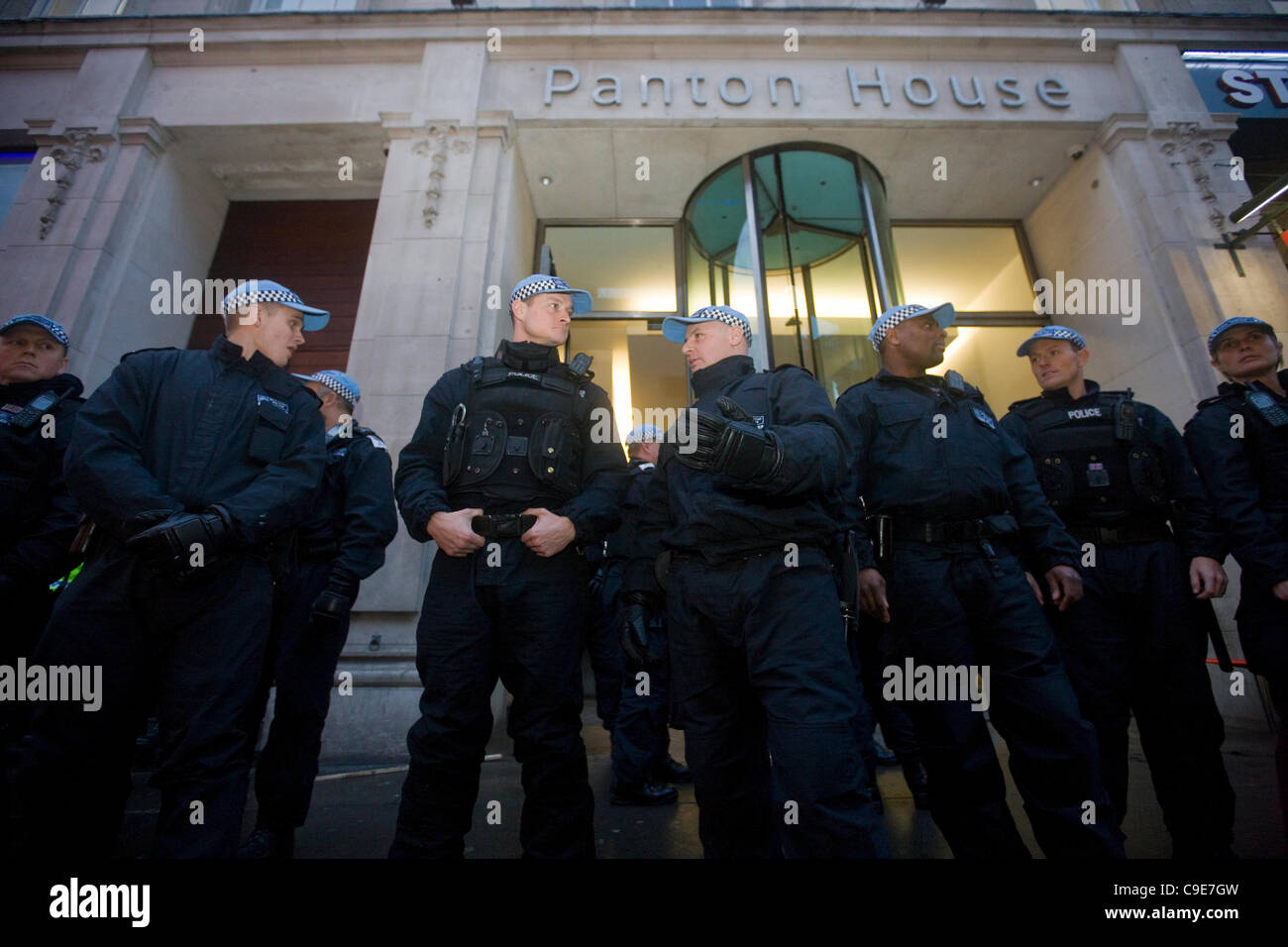 Haymarket, London, 30th Nov, 2011. Police officers guard the entrance to Panton House, off Haymarket, London, as protesters are arrested on the roof of the building. The occupation followed the Public Sector demonstrations in London. Stock Photo