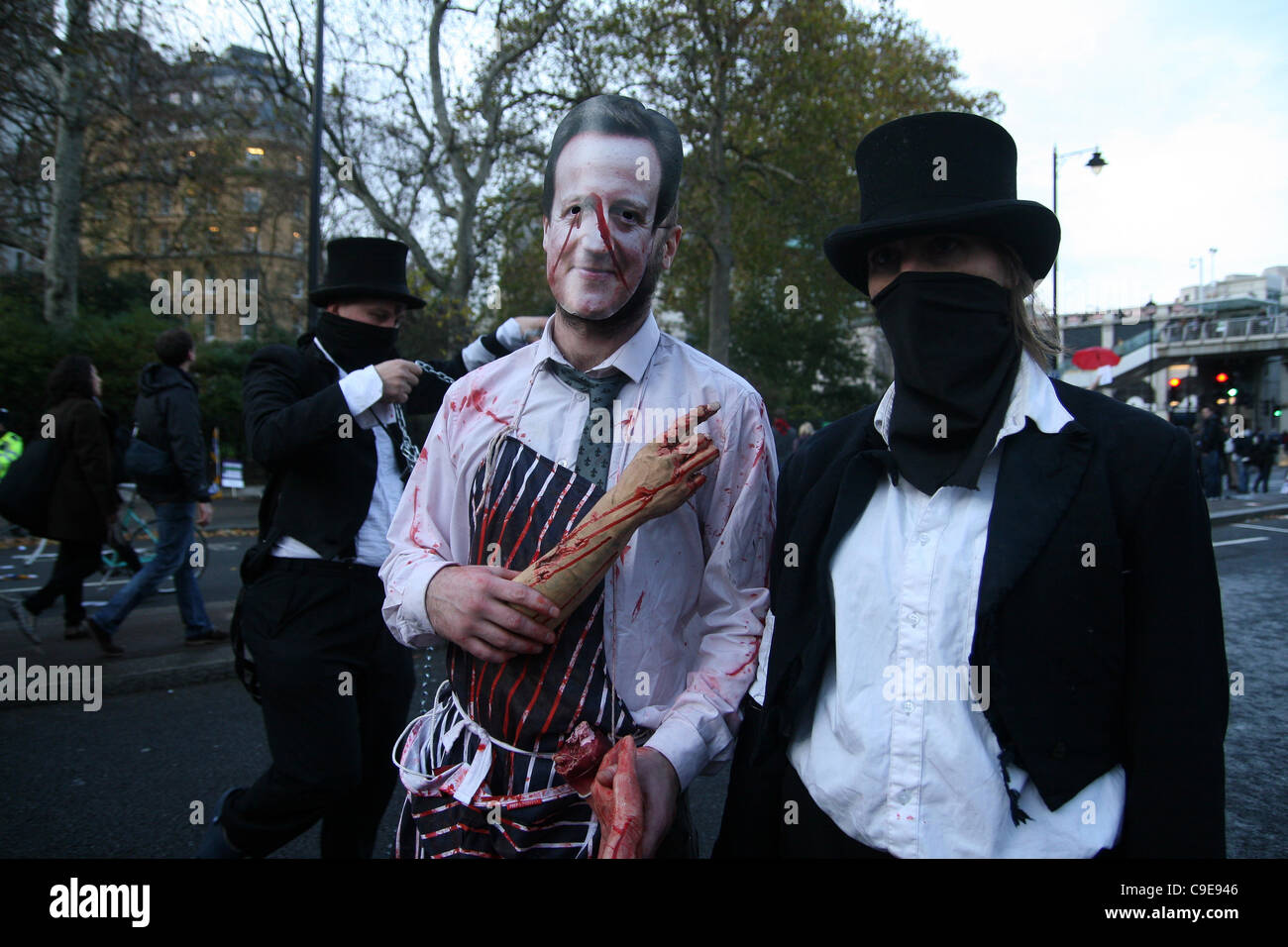 Anarchists dressed in David Cameron mask during a public sector workers strike in London, UK, on Wednesday 30th November, 2011. An estimated two million public sector workers took part in the UK-wide strike over Government proposals to change their pensions. Stock Photo