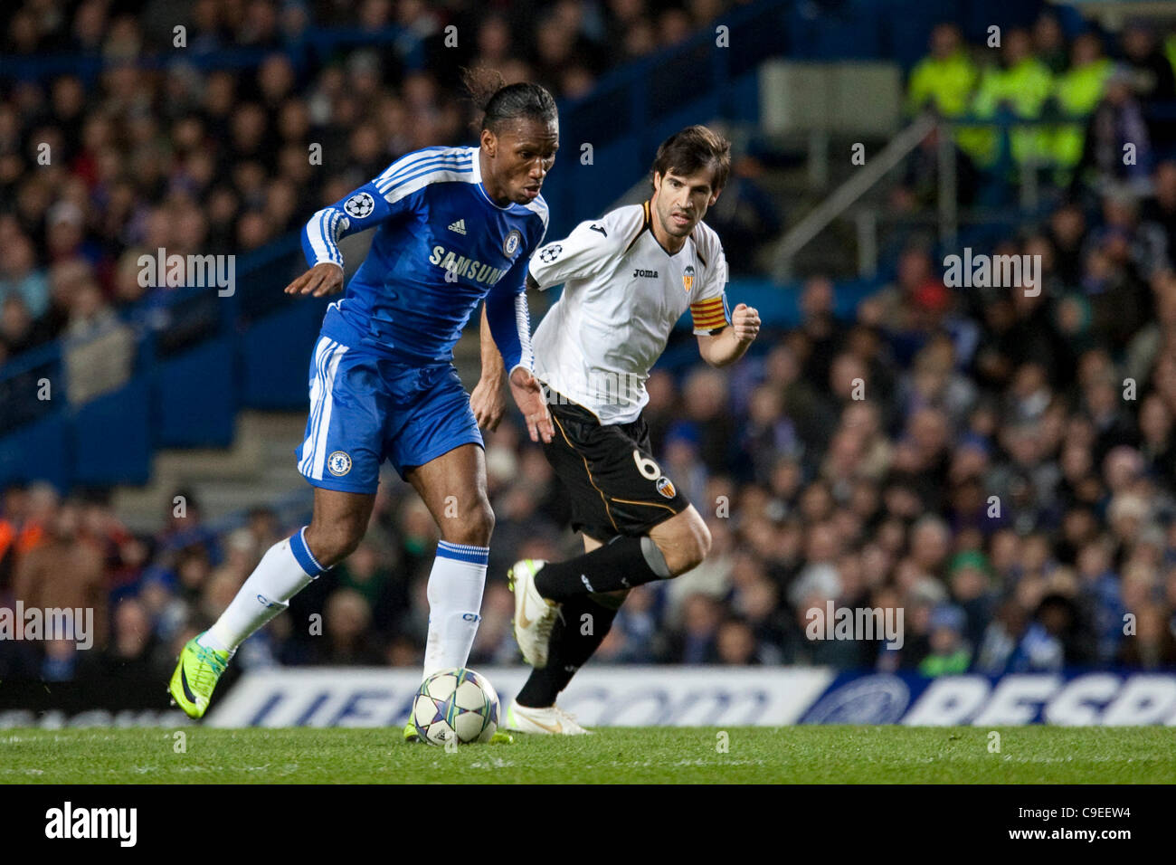 06.12.2011. London, England. Chelsea's Ivory Coast forward Didier Drogba and Valencia's Spanish midfielder David Albelda  in action during the UEFA Champions League group match between Chelsea and Valencia from Spain, played at Stamford Bridge Stadium. Stock Photo