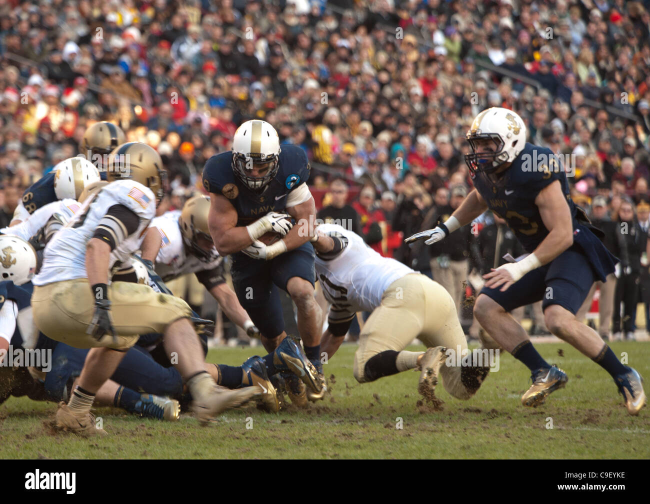 Navy's Alexander Teich plows through the middle of the Army defense in