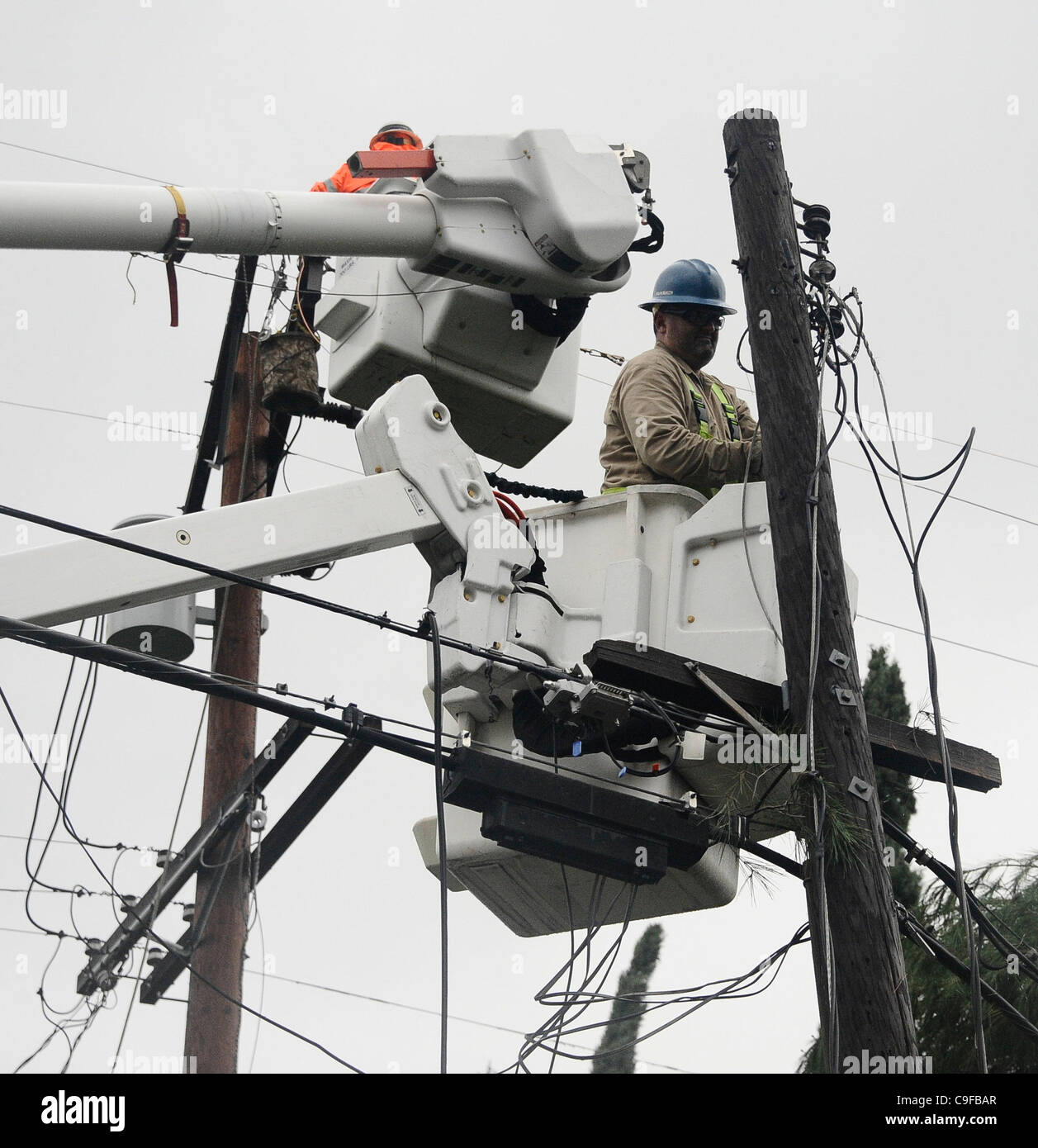 DWP workers work on power lines that have been damage by one of the