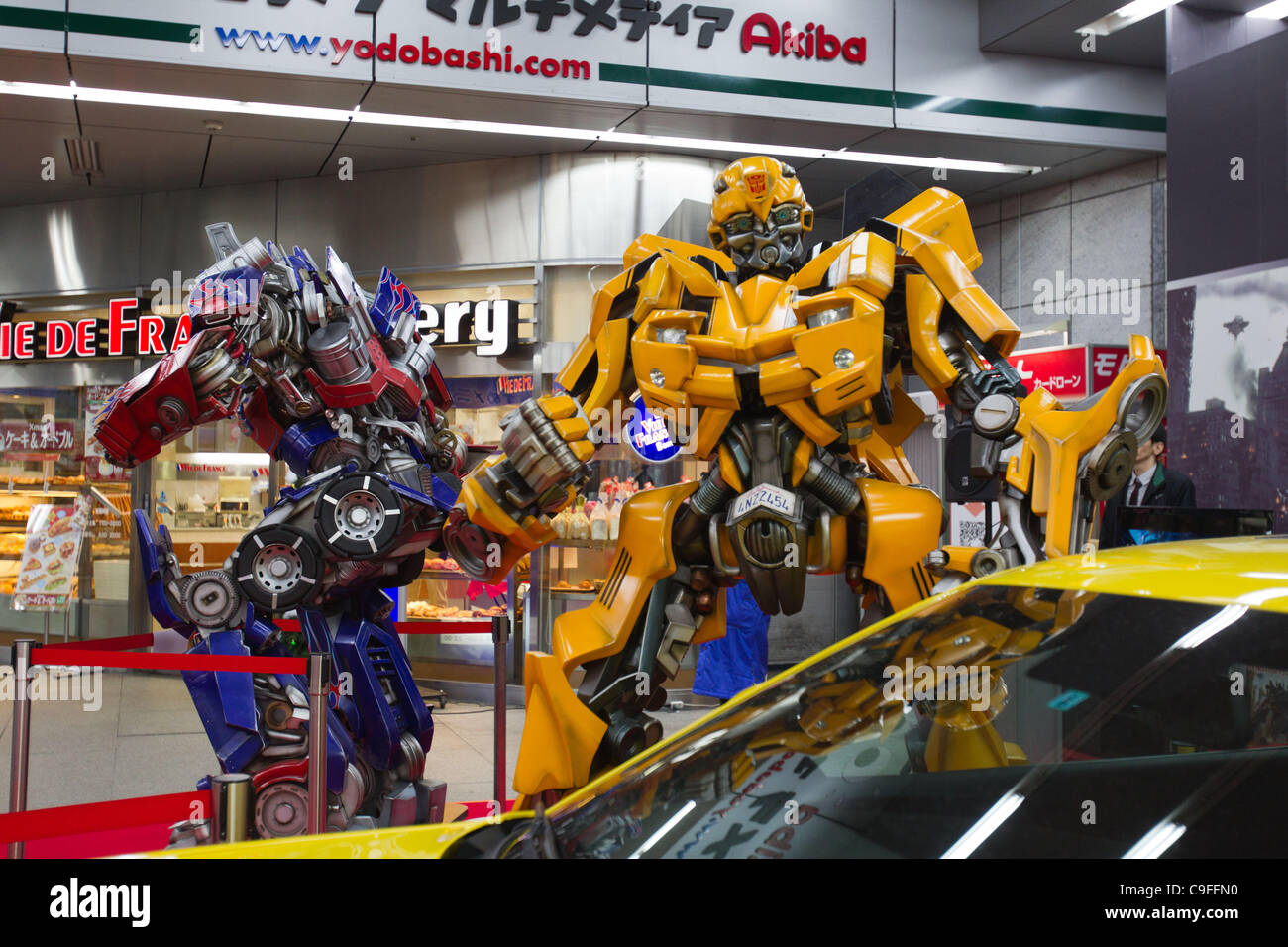 Dec 15, 2011, Tokyo, Japan - Large scale figures of Optimus Prime (left)  and Bumblebee (right) from the movie, "Transformers Dark Side of the Moon"  are displayed at a electronics store in