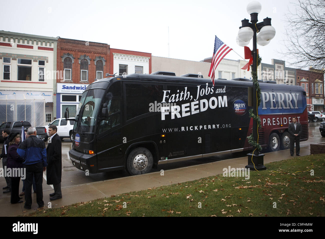 Dec. 14, 2011 - Harlan, Iowa, U.S. - Republican presidential candidate Texas Gov. Rick Perry talks with Dawn Cundiff of the Shelby County Chamber of Commerce as he campaigns during a Main Street Tour on the first day of his two week bus tour leading up to the Iowa Caucuses on Wednesday, December 14, Stock Photo