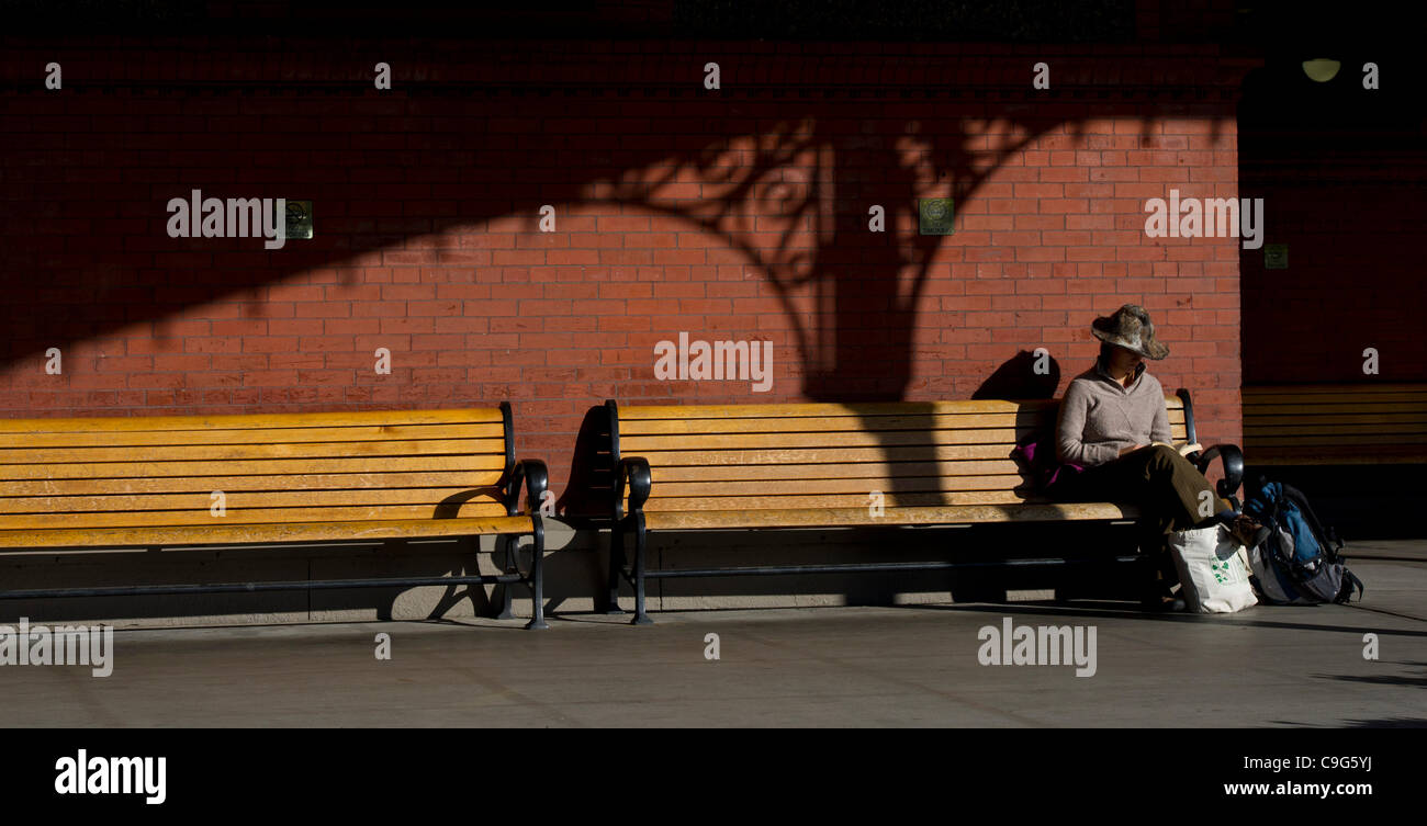 Dec. 9, 2011 - Portland, Oregon, United States - A woman reads a book as she waits at Union Station in Portland, Oregon. Union Station is a public transportation source for Amtrak trains and the TriMet system in Portland. (Credit Image: © Jim Z. Rider/ZUMAPRESS.com) Stock Photo