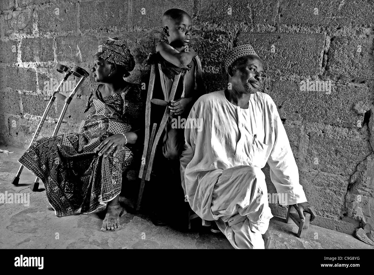 Sept. 27, 2010 - Kano, KANO, NIGERIA - Mr. Aminu Ahmen El Wada, the Founder and Chairman of the Kano State Polio Victims Trust Association and his wife Khadija Aminu, both crippled for many years with polio, with their son Umar, 8, also crippled with polio at their home in Kano, Nigeria. There are s Stock Photo