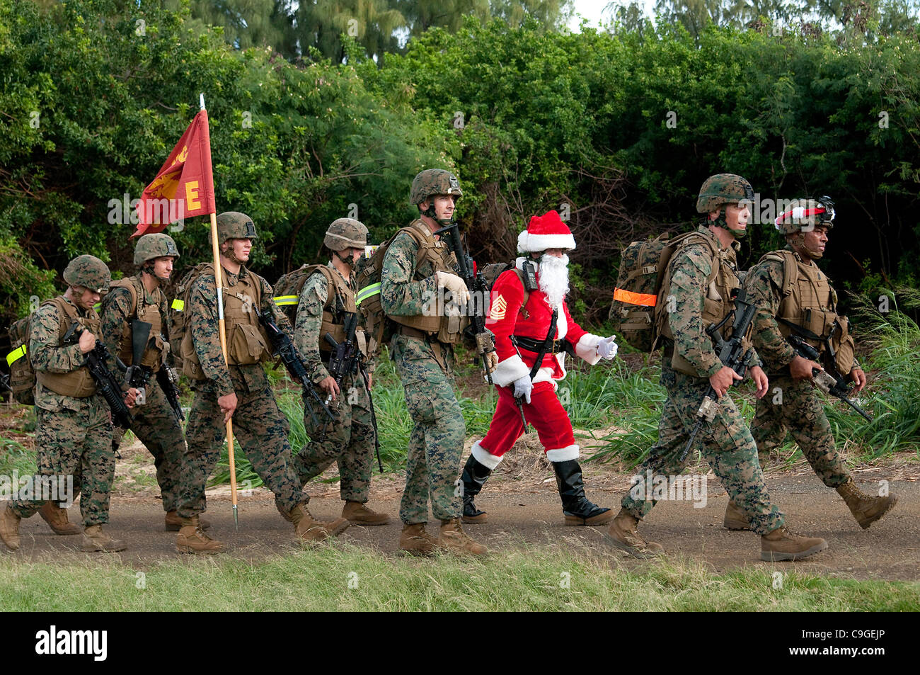 Santa Claus marches along with Marines from 2nd Battalion, 3rd Marine Regiment at the Boondocker training December 19, 2011 at Kaneohe Bay, Hawaii. The Marines were participating in the Island Warrior Combat Competition III and Toys for Tots drive at the Marine Corps Base Hawaii. Stock Photo