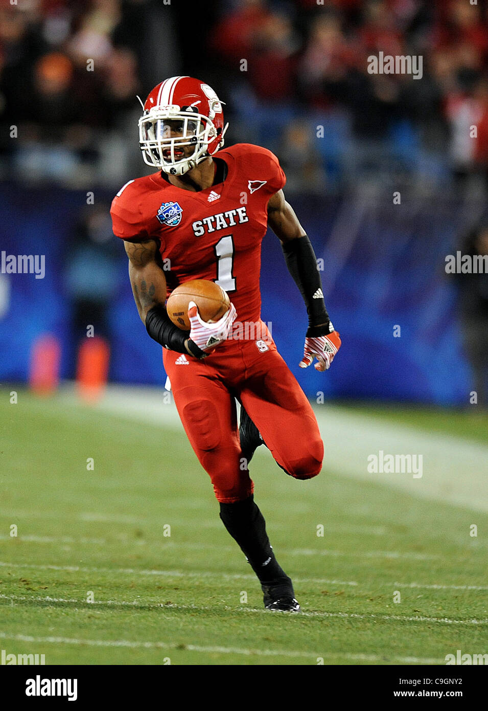 Dec.27, 2011 - Charlotte, North Carolina; USA -  North Carolina State Wolfpack (1) DAVID AMERSON runs for a touchdown as the North Carolina State Wolfpack compete against The University of Louisville Cardinals in the Belk Bowl College Football game that took place at the Bank of America Stadium.  Co Stock Photo