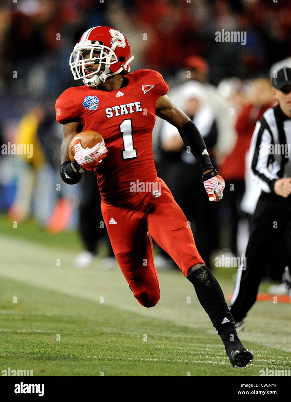 Dec.27, 2011 - Charlotte, North Carolina; USA -  North Carolina State Wolfpack (1) DAVID AMERSON runs for a touchdown as the North Carolina State Wolfpack compete against The University of Louisville Cardinals in the Belk Bowl College Football game that took place at the Bank of America Stadium.  Co Stock Photo