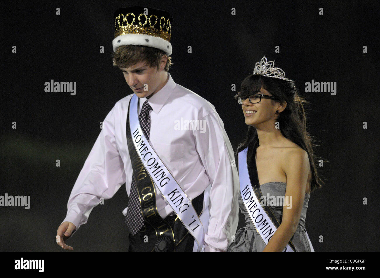 October 28, 2011 - Orlando, Florida, U.S. - ARIANNA MUNIZ, daughter of singer MARC ANTHONY, and MICHAEL BENNETT, left, walk off the football field after being crowned Homecoming Queen and King for Bishop Moore high school. (Credit Image: © Phelan Ebenhack/ZUMApress.com) Stock Photo