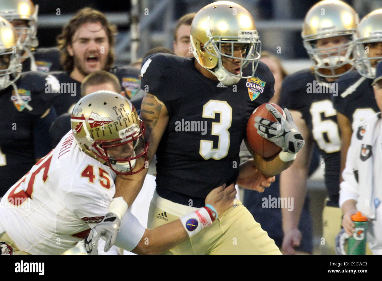 Dec. 29, 2011 - Orlando, Florida, U.S - Notre Dame Fighting Irish wide receiver Michael Floyd (3) is tackled by Florida State Seminoles punter Shawn Powell (45) during the 2011 Champs Sports Bowl between the Florida State Seminoles and Notre Dame Fighting Irish. Florida State Won 18-14. (Credit Imag Stock Photo