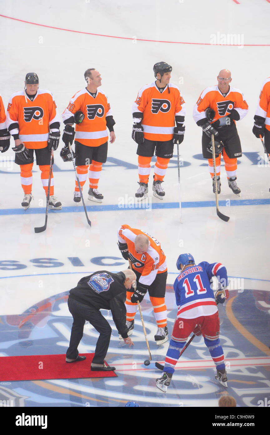 Dec. 31, 2011 - Philadelphia, Pennsylvania, U.S - Philadelphia Flyers Alumni center, and captain, Bob Clarke (16), faces off with New York Rangers Alumni center, and captain, Mark Messier (11) with the puck dropped by Flyers founder Ed Snider before first period NHL Winter Classic Alumni game action Stock Photo
