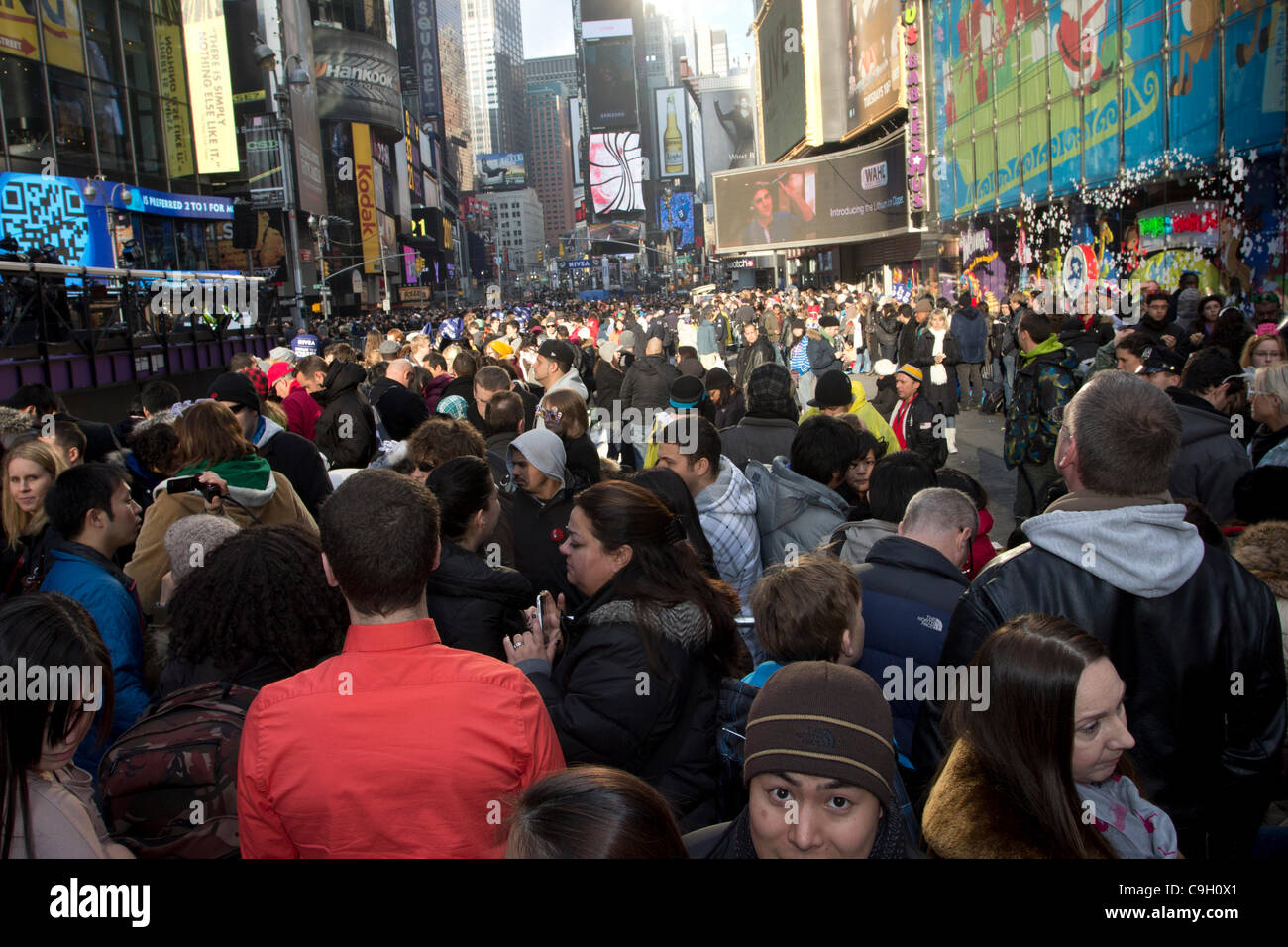 Crowds in New York City's Times Square await the arrival of 2012 on New Year's Eve. More than one million people from around the world will eventually join the celebration in the Big Apple. Stock Photo
