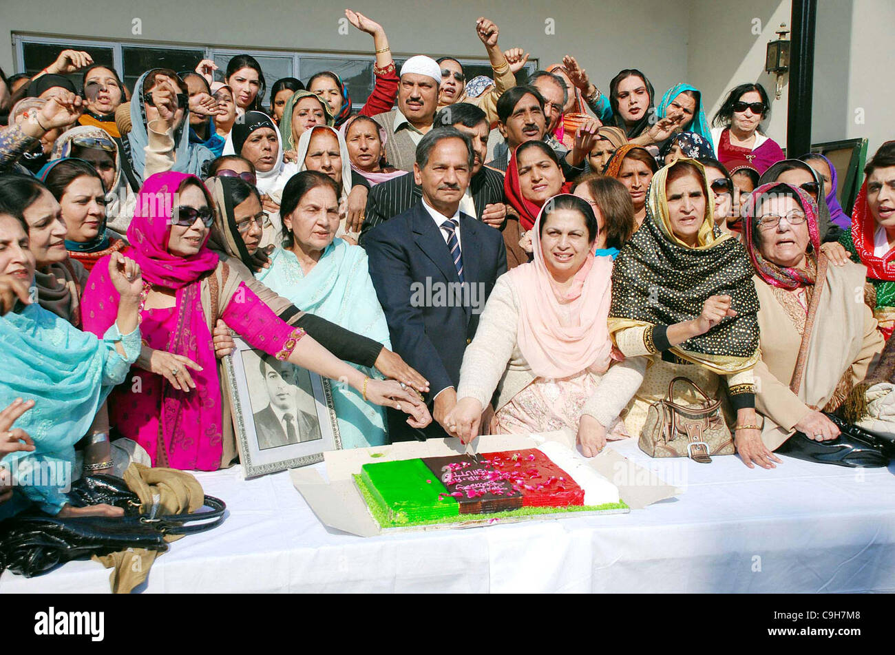 Activists of Peoples Party cut cake during ceremony in connection of the Birthday Anniversary of PPP Founder Zulfiqar Ali Bhutto Stock Photo