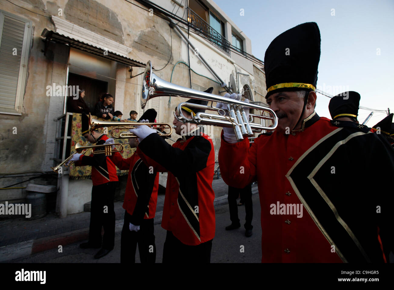 An Israeli Arab Christian marching band passing by a Muslim family