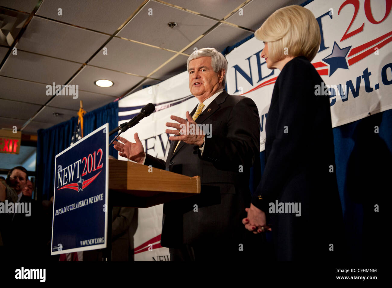 Manchester, NH, Unites States - 1/8/12 -   Former Speaker of the House Newt Gingrich, with wife Callista, right, speaks during a campaign stop in Manchester, NH January 8, 2012, as he campaigns for the Republican nomination for President prior to the New Hampshire Primary.     (Photo by Gordon M. Gr Stock Photo