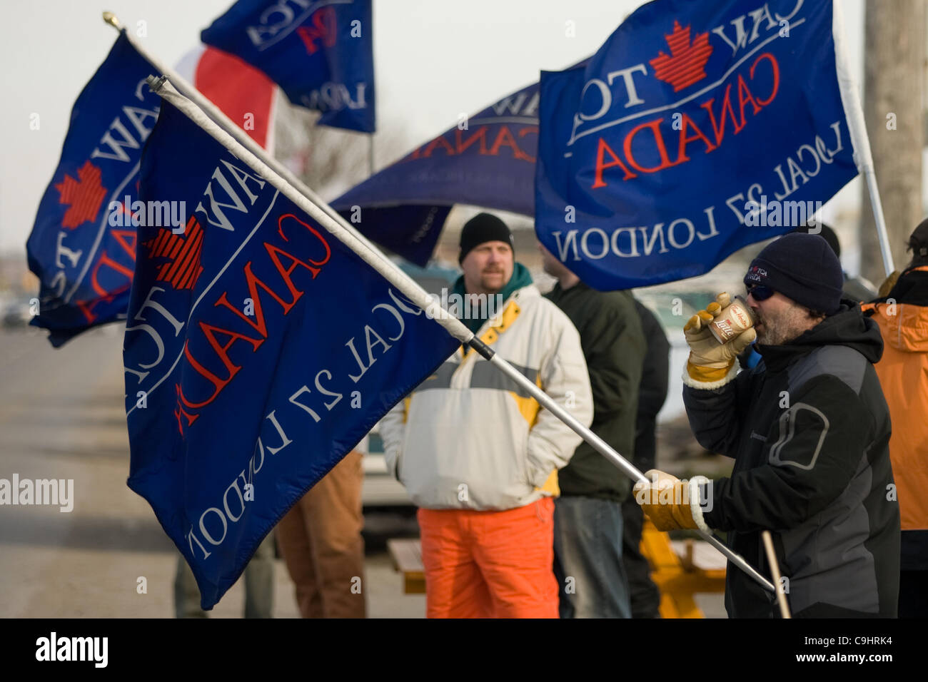 London Ontario, Canada - January 9, 2012. Locked out Electro Motive workers walk the picket line in front of the factory located in London. The company, owned by Caterpillar locked out more than 700 union and non-union workers on January 1, 2012 at the Canadian Auto Workers union rejected the compan Stock Photo