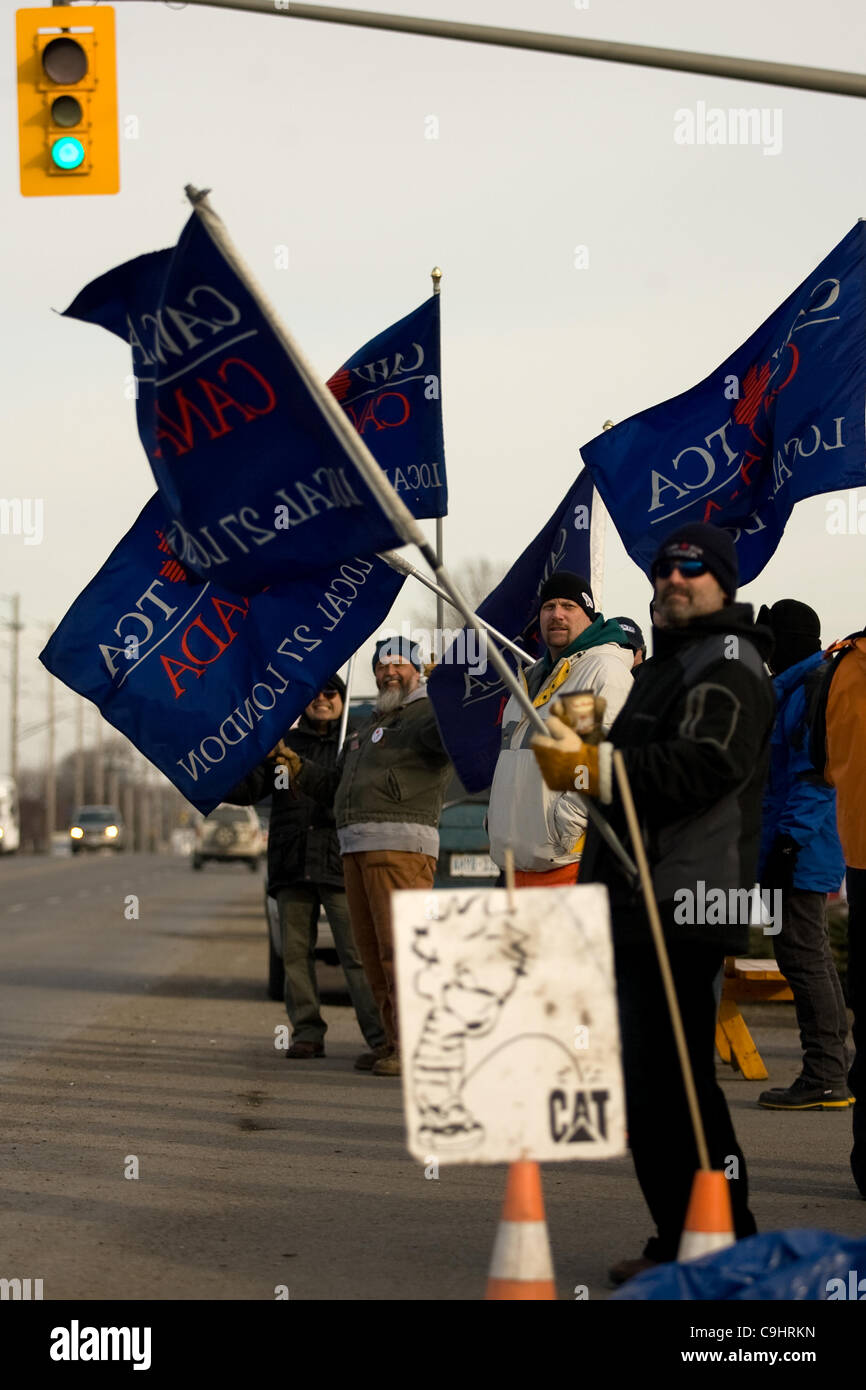 London Ontario, Canada - January 9, 2012. Locked out Electro Motive workers walk the picket line in front of the factory located in London. The company, owned by Caterpillar locked out more than 700 union and non-union workers on January 1, 2012 at the Canadian Auto Workers union rejected the compan Stock Photo