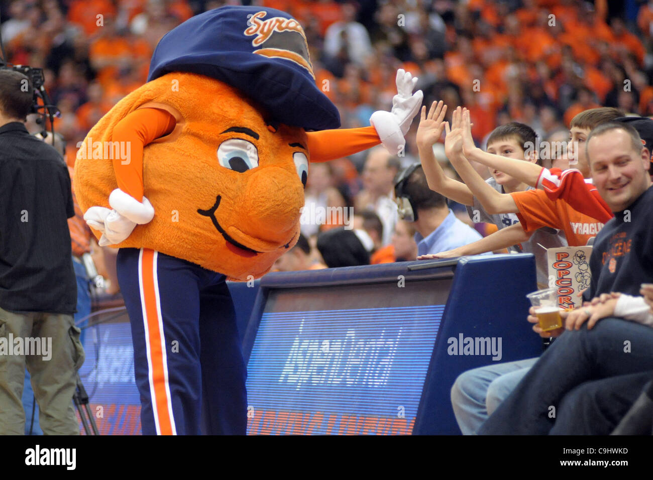 Jan. 7, 2012 - Syracuse, New York, U.S - Syracuse Orange mascot Otto high fives some fans before the start of the game at the Carrier Dome in Syracuse, NY.  Number one ranked Syracuse leads Marquette 37-19 at the half. (Credit Image: © Michael Johnson/Southcreek/ZUMAPRESS.com) Stock Photo