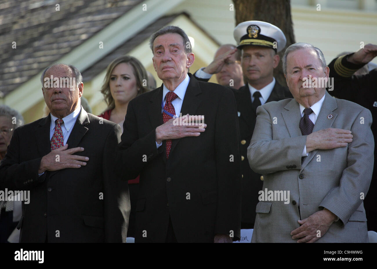 Jan. 9, 2012 - Los Angeles, California, U.S. - Col. Jack Brennan (L), President Nixon's brother Ed Nixon (center) and John Barr, Nixon Foundation board member John Barr(R) and U.S. Navy Rear Admiral Mike Shatynski (back R) stand at attention for the U.S. Navy color guard during President Richard Nix Stock Photo