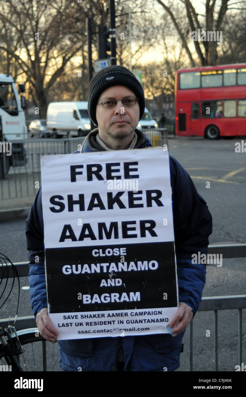 London, UK. 11th Jan, 2012. A protester holds up a placard which states: 'Free Shaker Aamer' during the Guantànamo Day of Action - At 8am protesters in Turnpike Lane, London mark the 10th anniversary of the opening of the US prison camp. Amnesty International today released a report on the prison. Stock Photo