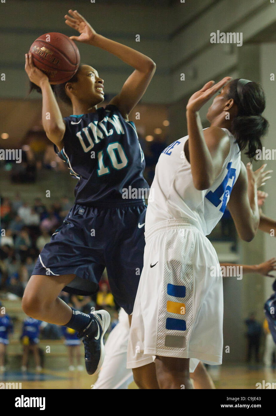 Jan. 12, 2012 - Newark, Delaware, United States of America - 01/12/12 Newark DE: University of North Carolina Wilmington Sophomore Guard Abria Trice #10 attempts a shot under the basket while Delaware Forward #12 Danielle Parker (Right) defends during a Colonial Athletic Association Conference Baske Stock Photo