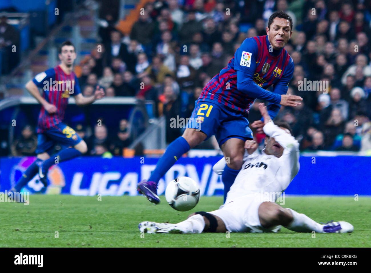 18/01/2011 - MADRID, Spain // COPA DEL REY FOOTBALL - Real Madrid vs. Barcelona - 1/4 finals - Santiago Bernabeu ------------- Alexis from FC Barcelona receiving a tackle from Carvalho Stock Photo