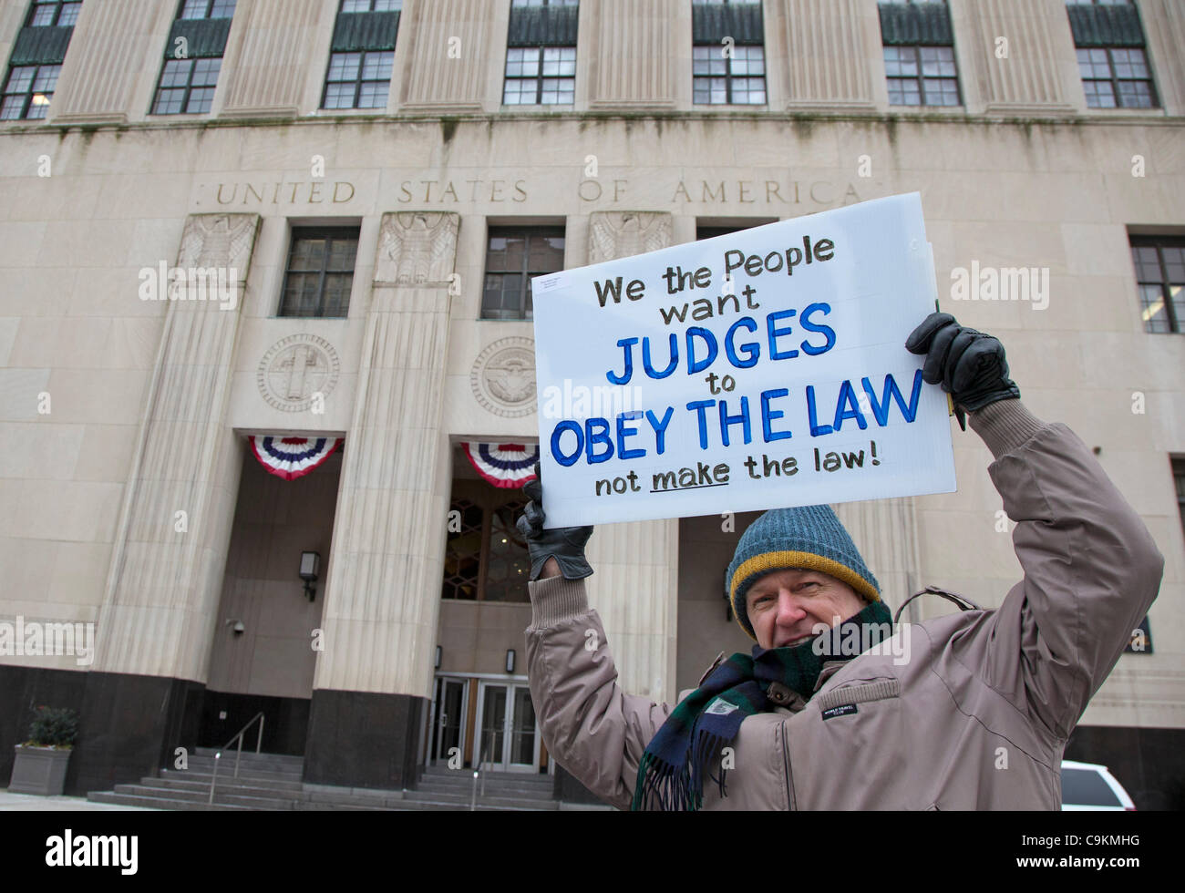 Detroit, Michigan - Activists mark the second anniversary of the Supreme Court's 'Citizens United' decision by picketing the federal courthouse. 'Citizens United' opened the way for corporations to make unlimited contributions to support or oppose political candidates. Stock Photo