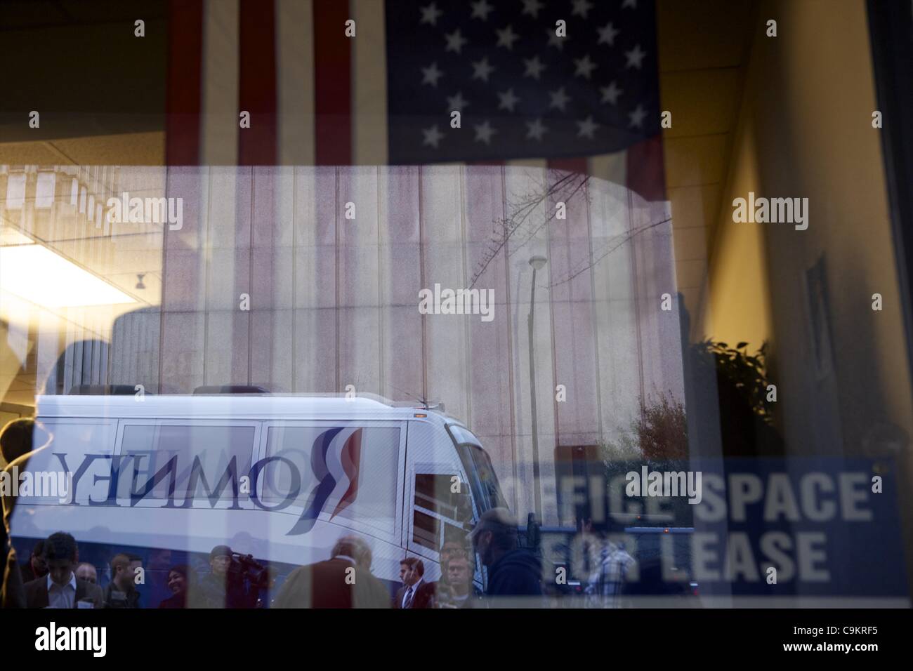Jan. 21, 2012 - Greenville, SC, U.S - The campaign bus of Republican Presidential candidate Mitt Romney and a mascot from a nearby tire store are reflected at a storefront next door to Romney Greenville campaign headquarters during his morning visit on the day of the South Carolina primary. (Credit  Stock Photo