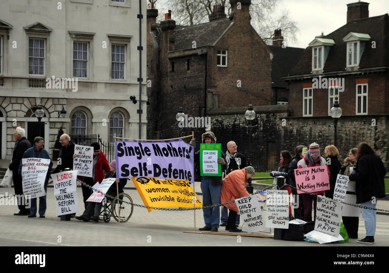 London, UK. 23/01/12. Members of 'Justice for Vulnerable Debtors','Legal Action for Women', 'Single Mothers' Self Defence', 'WinVisible', and 'UKUncut' take part in a protest outside Parliament against the Welfare Reform Bill.  Stock Photo