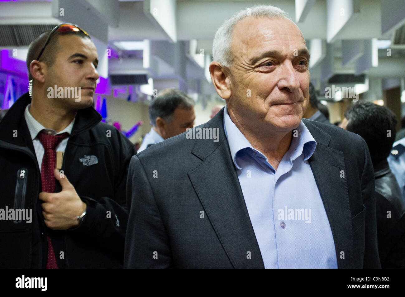 Minister of Internal Security Yitzhak Aharonovitch (R) leaves police headquarters mess hall followed by security agent at conclusion of a festive ceremony awarding ranks to senior police officers. Jerusalem, Israel. 30th January 2012. Stock Photo