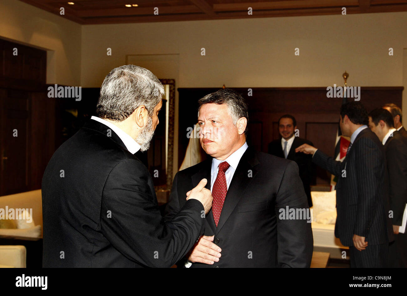 Jan. 29, 2012 - Amman, Amman, Jordan - Jordan's King Abdullah (R) chats with senior Hamas leader Khaled Meshaal on his arrival at the Royal Palace in Amman January 29, 2012. Meshaal on Sunday made his first official visit to Jordan since the kingdom expelled him more than a decade ago and held talks Stock Photo