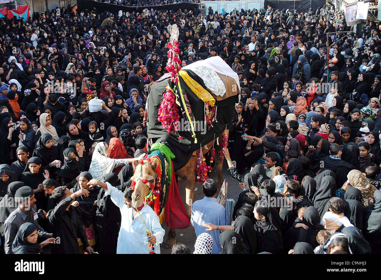 Shiite mourners touch Ziarat during the Chup Taziya procession of Eight Rabi-ul-Awal at Qadamgah Moula Ali (AS) in Hyderabad on Wednesday, February 01, 2012. Stock Photo