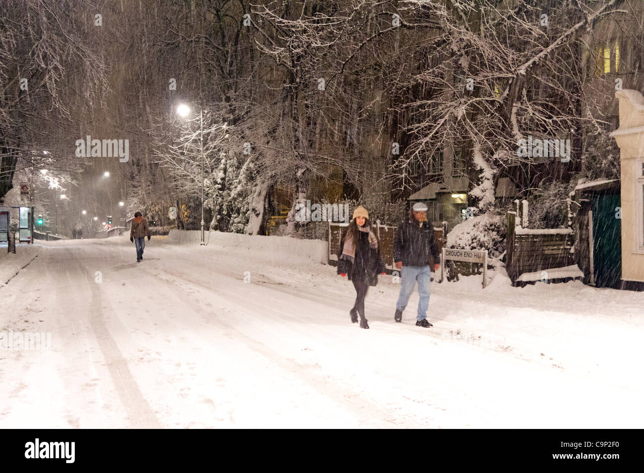 London, UK. 5th Feb, 2012. Couple walking down deserted road during winter storm - Crouch End - London - in the early hours of Sunday morning. Stock Photo