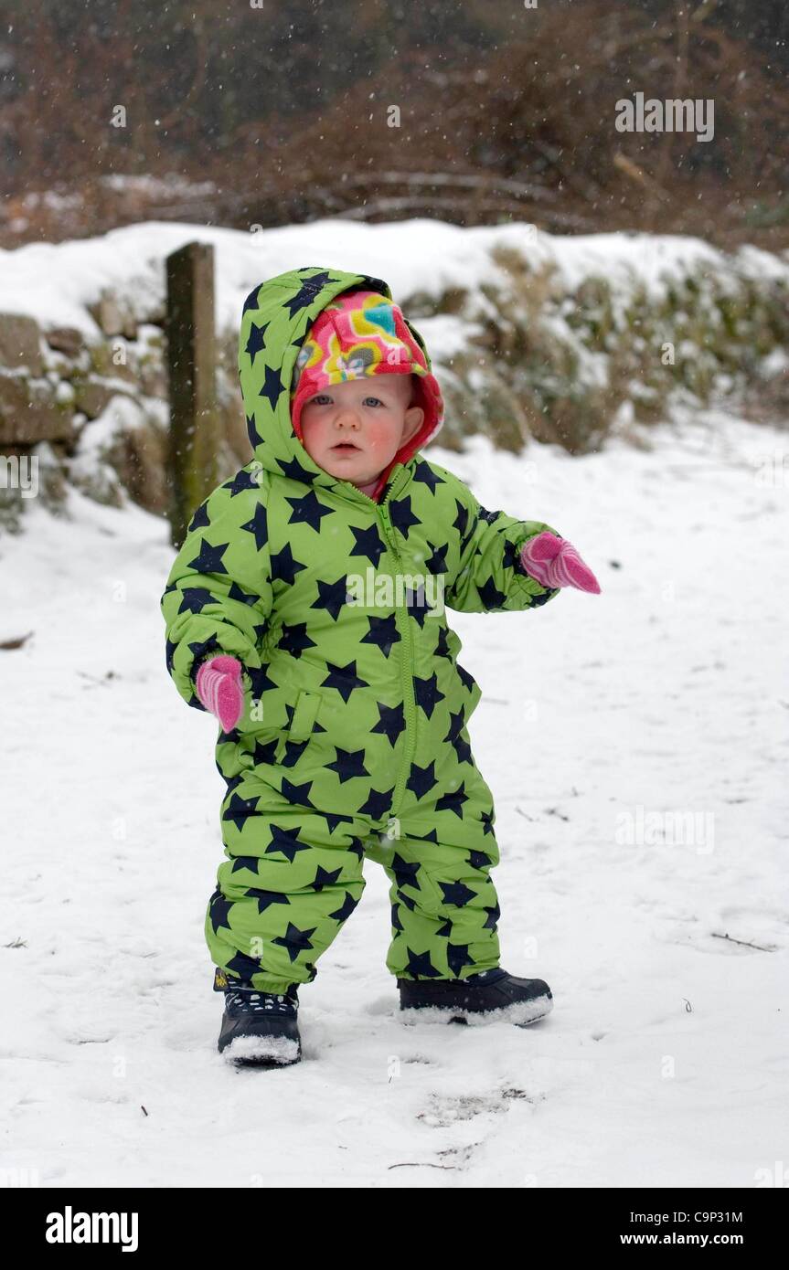 One year old Roxanne from Swansea wrapped up against the cold on the way up to Pen Y Fan in the  Brecon Beacons National Park in mid Wales this afternoon as snow blanketed the area. She was experiencing snow for the first time. Stock Photo